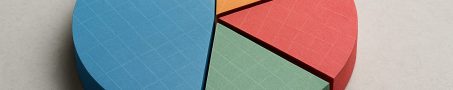 A 3D pie chart made of colorful card stock segments arranged on a neutral background.