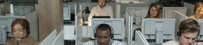 A diverse group of call center agents working in an organized office setting, focused on assisting customers. — Prop Trading